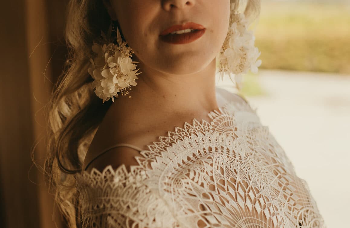 Close-up of a bride in lace with a red lip
